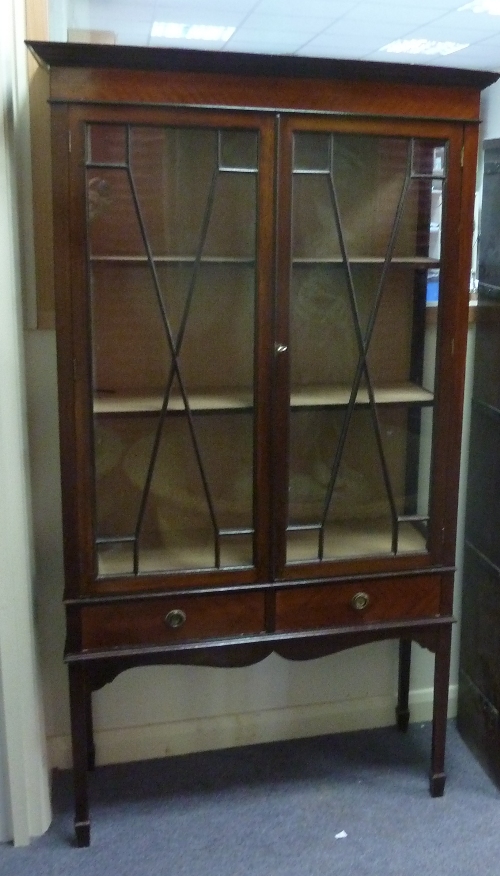 A mahogany display cabinet, the astragal glazed panel doors above two short drawers on square legs