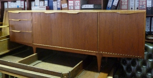 A McIntosh Furniture sideboard, fitted a pair of cupboard doors to the centre flanked by three