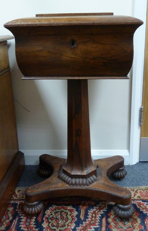 A Regency rosewood teapoy with hinged lid, on an octagonal support to a platform base with reeded