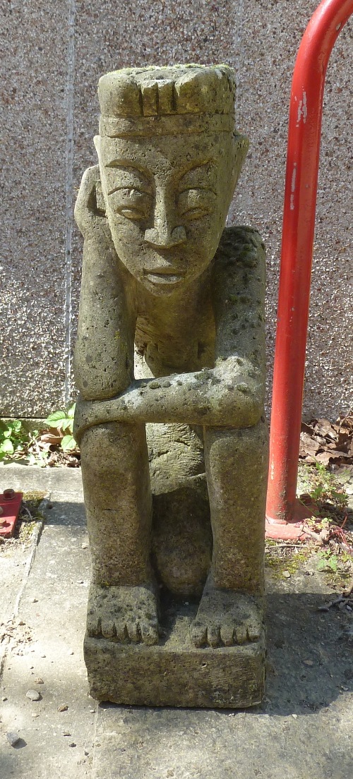 A reconstituted figure of a seated grotesque, 74cm ( 29") high