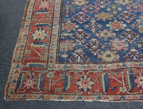 A Tabriz carpet, the central madder medallion on an indigo ground within a madder guard stripe,