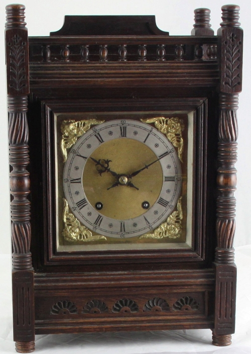 A W & B mantel clock with gong strike and brass dial on an oak Aesthetic movement case, 39.5cm x