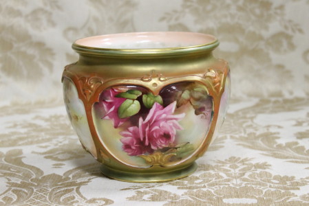 A superb English Royal Worcester jardinière having four hand painted floral panels, signed Austin.