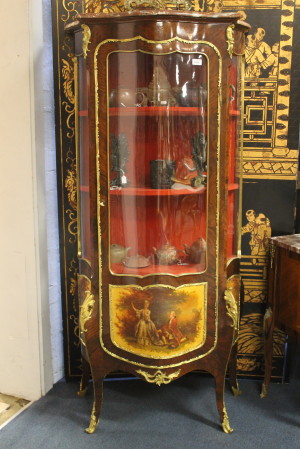 An exceptional French 19th century bombe shaped vitrine having veni martin panels and fine ormolu