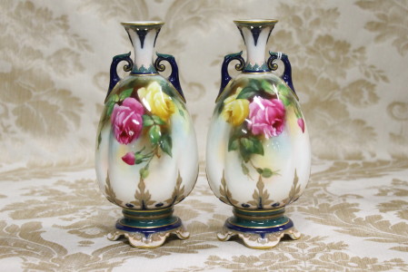 A lovely pair of English Royal Worcester two handled vases having hand painted rose decoration,