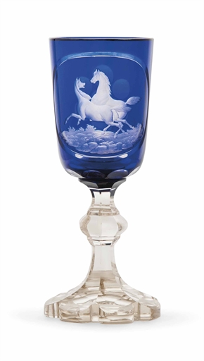 A BOHEMIAN BLUE OVERLAY CUT AND ENGRAVED GLASS GOBLET
MID-19TH CENTURY
The bowl engraved with two