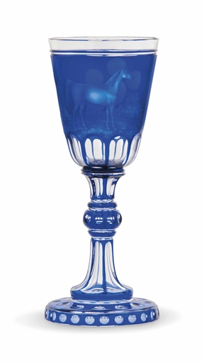 A BOHEMIAN BLUE OVERLAY CUT AND ENGRAVED GLASS GOBLET
CIRCA 1870
The round funnel bowl engraved with