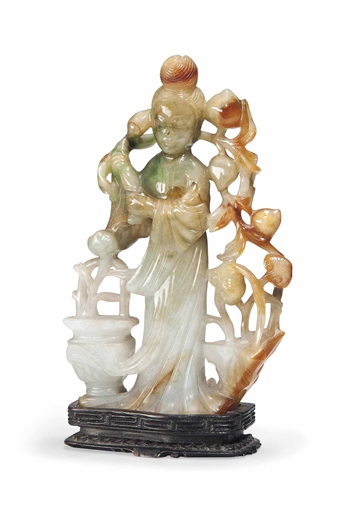 A CHINESE JADEITE CARVING OF A LADY
CIRCA 1900
Carved with a standing lady holding a long spray of