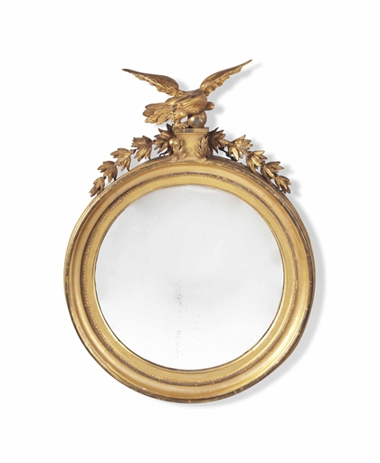 A REGENCY GILTWOOD CONVEX MIRROR
EARLY 19TH CENTURY
With eagle cresting
40 in. (102 cm.) high; 28