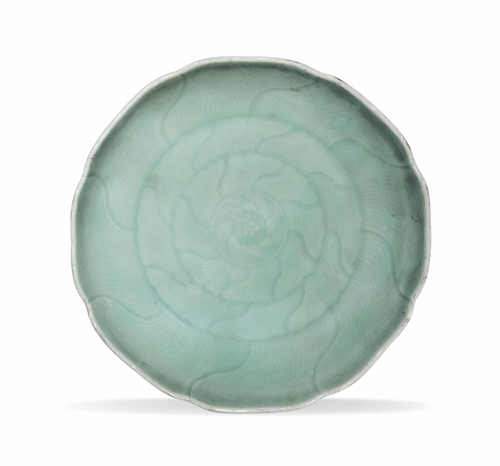 A CHINESE CELADON-GLAZED DISH
18TH CENTURY
With a foliate rim, moulded with a stylised floral