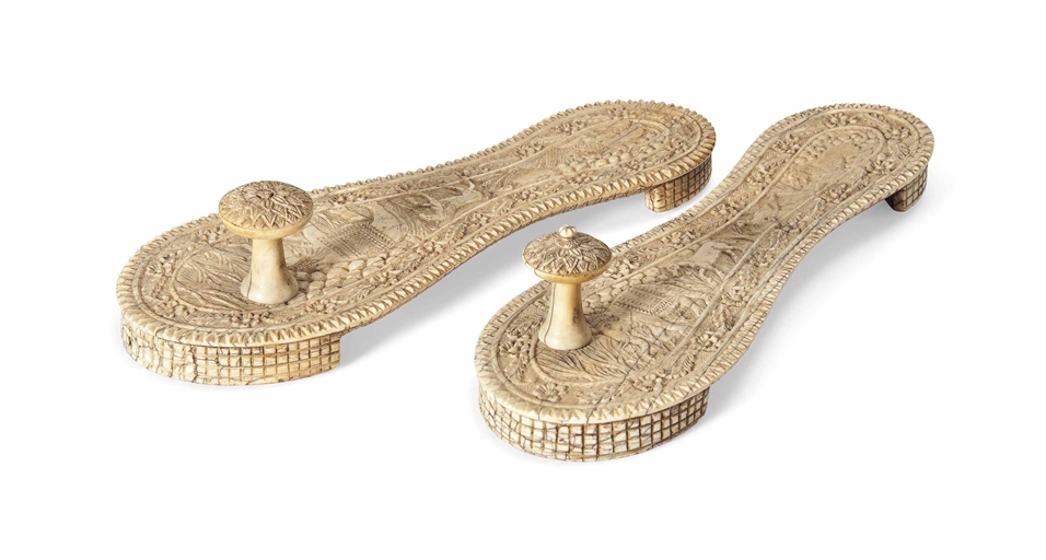 A PAIR OF CARVED IVORY TOE-KNOB SANDALS (PADUKAS)
INDIA OR SRI LANKA, 19TH CENTURY
Of paddle