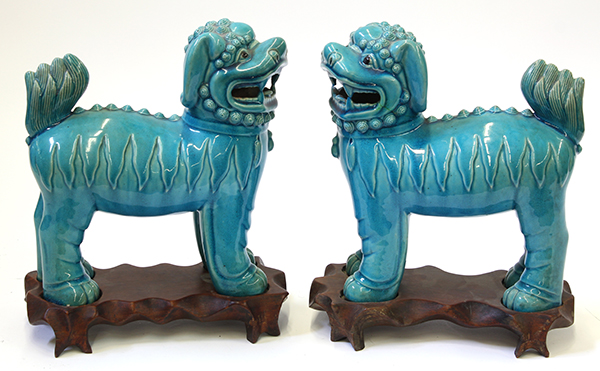 Pair of Chinese turquoise glazed porcelain lions, standing on all fours and with head slightly