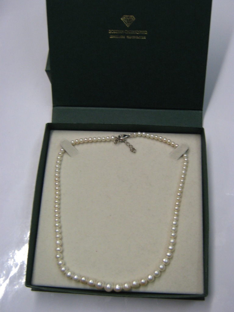 A single strand cultured pearl necklace with silver clasp and original box
