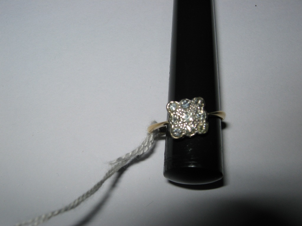 An 18ct Yellow & White gold nine stone old cut diamond ring, with valuation certificate