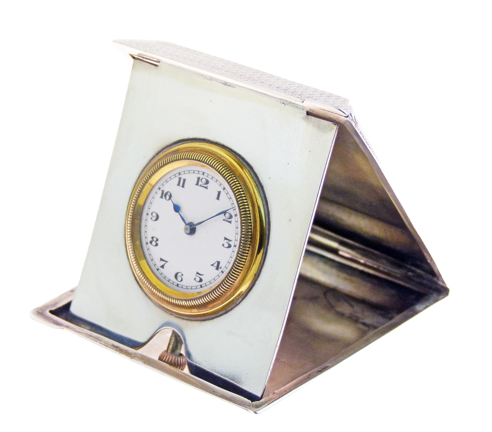 George V engine turned silver cased travel clock, the circular white enamel dial with Arabic