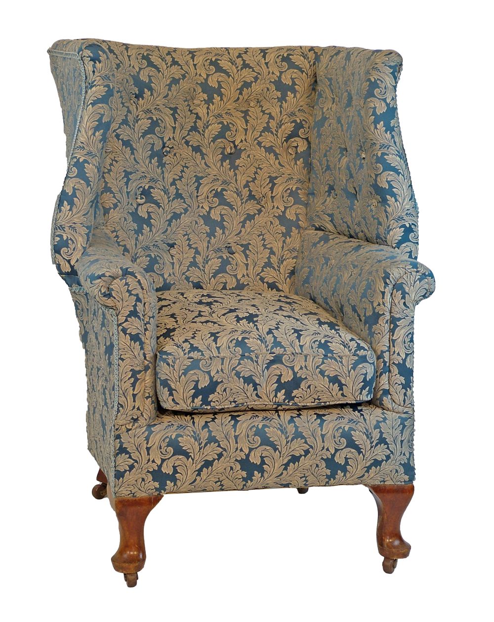 Early 20th Century wing back porter`s chair upholstered in blue and off-white brocade and standing o