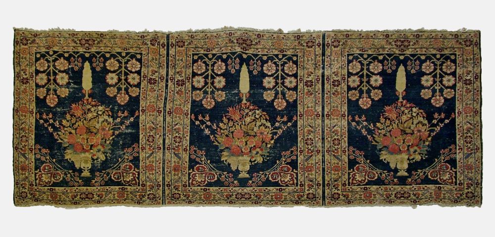 Middle Eastern triple rug, the three joined panels each decorated with a vase of flowers on a blue w