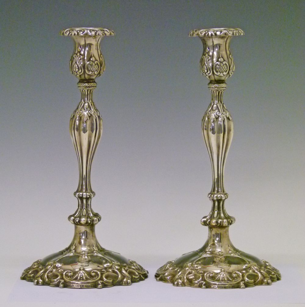 Pair of Victorian silver candlesticks, each having Neo-classical embossed decoration, slender