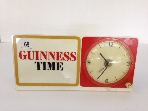 An early 20th century Guinness plastic bar top advertising illuminated electric clock.