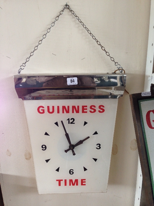 An early 20th century perspex Guinness advertising wall clock with chrome mount: 'Guinness Time'.