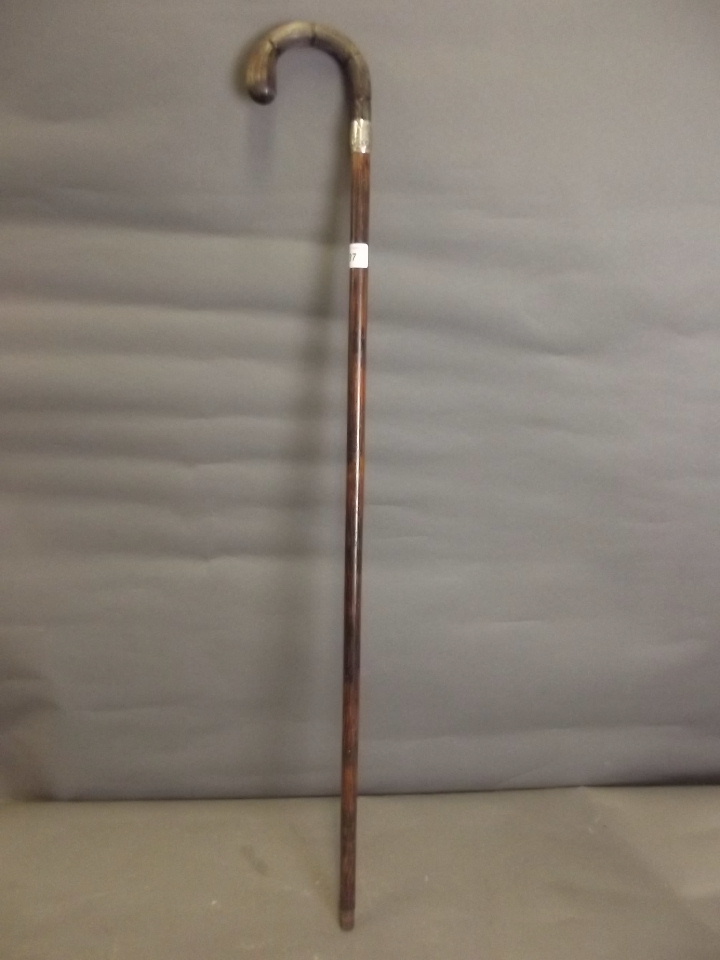 A horn handled walking stick with a silver mount, marked indistinctly, 35`` long