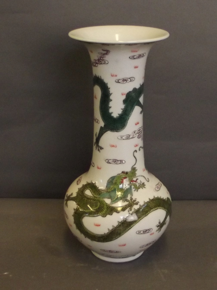 A Chinese long necked vase decorated with two dragons chasing the flaming pearl, 6 character mark,