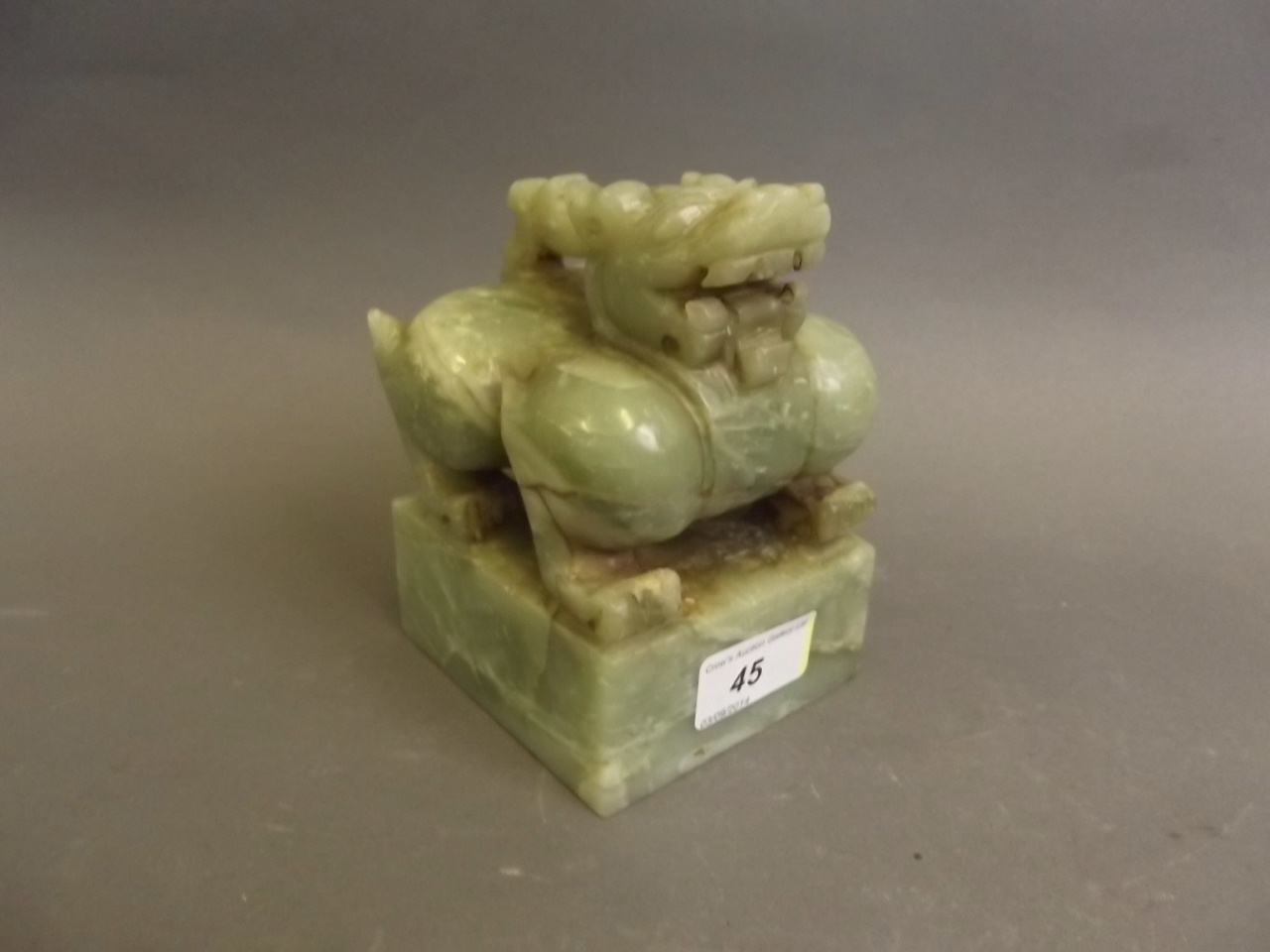 A large Chinese carved jade square form seal surmounted by a dragon, 3½'' x 3¾'', 5½'' high