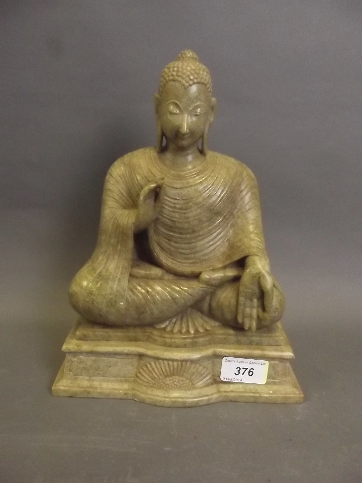 A fine Oriental carved soapstone Buddha wearing flowing robes 11" high