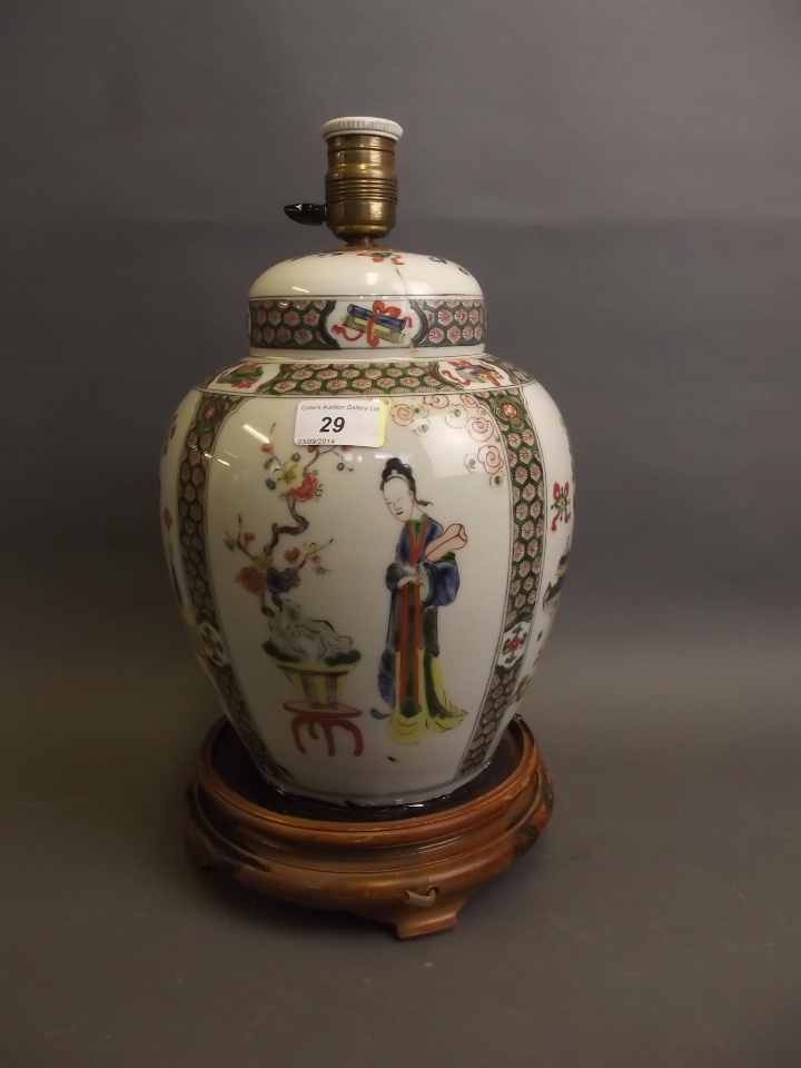 A large Chinese pottery jar and cover painted in Doucai enamels, converted to a table lamp, on a