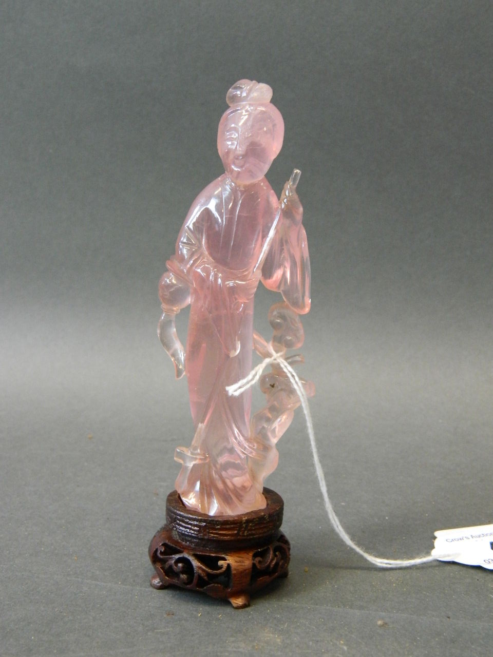 An early C20th Chinese rose quartz figure of Guan Yin on a later wood stand, figure A/F (head