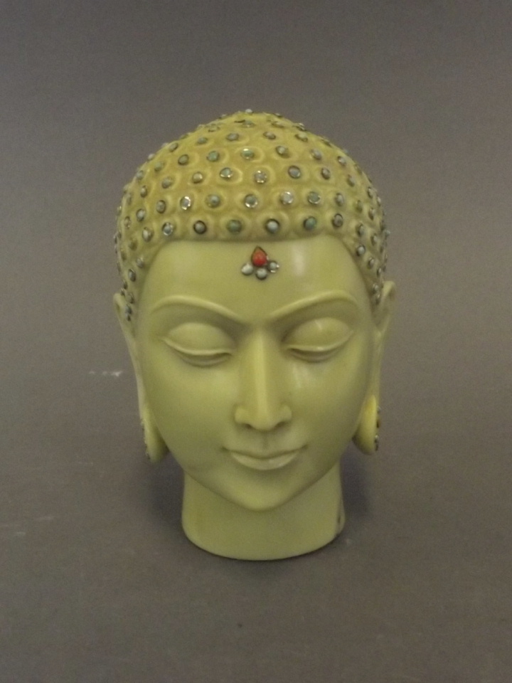 An unusual Eastern carved marble head of buddha inset with turquoise and cornelian, 3½" high