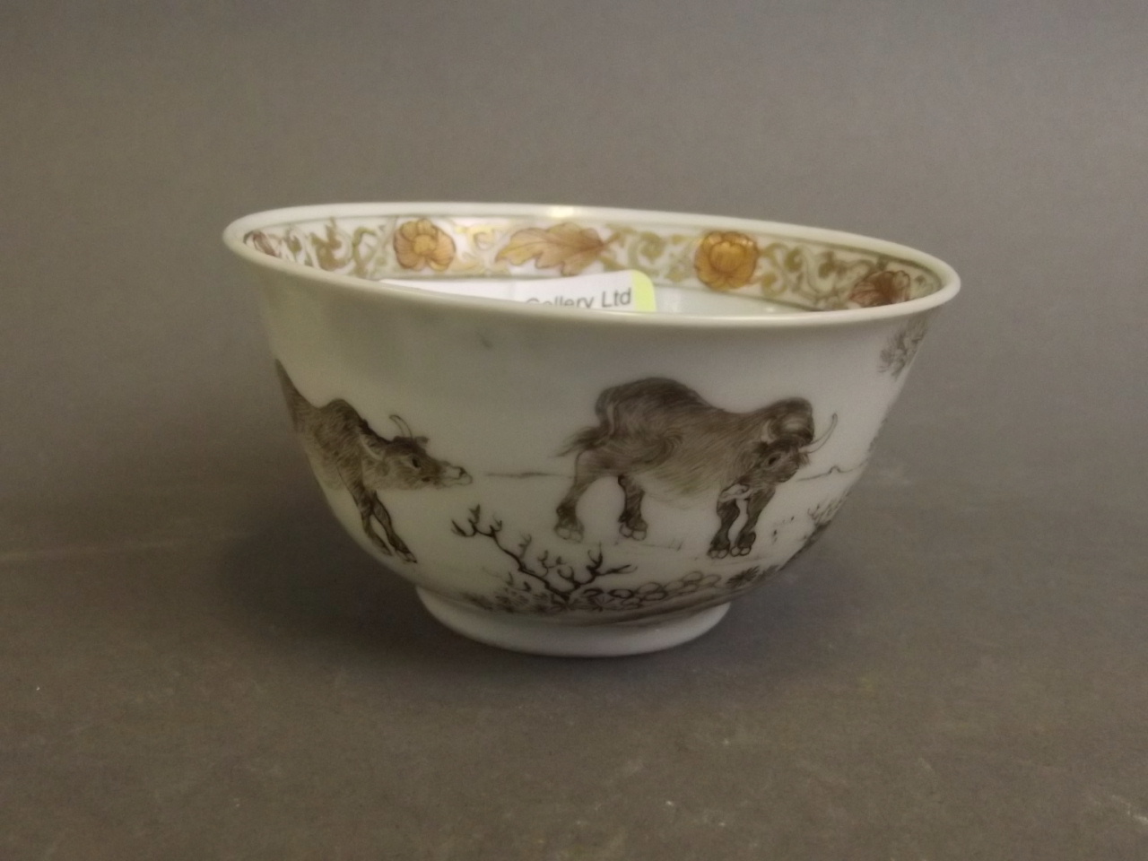 An unusual C19th Chinese tea bowl painted with water buffalo in a landscape, 3" diameter