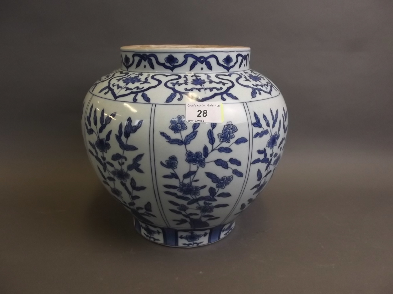 A good early Chinese blue and white pottery jar painted with panels of flowers and rockwork, 10"