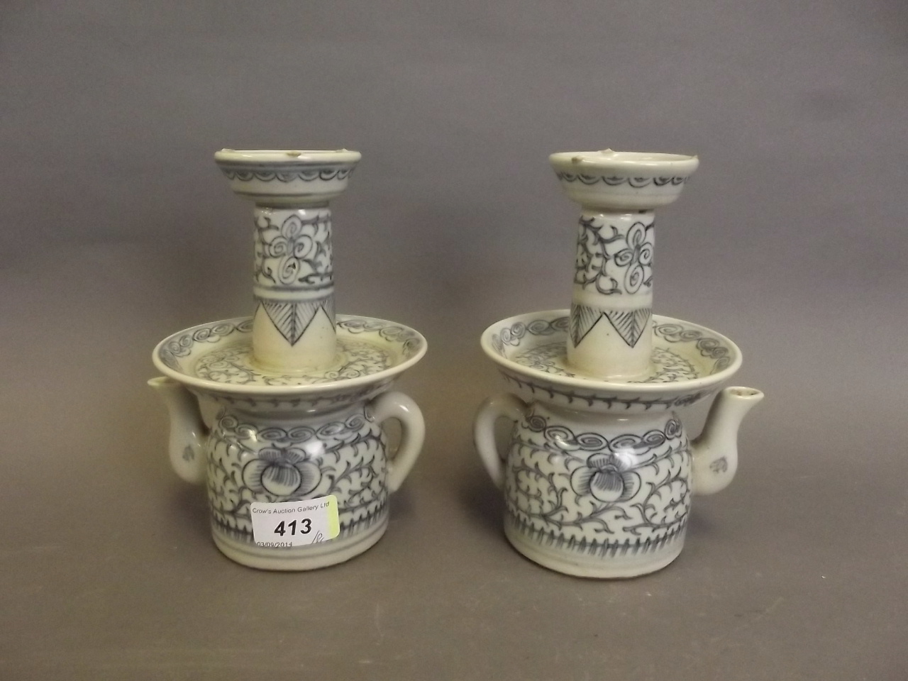A pair of Chinese blue and white pottery candlesticks, 7" high