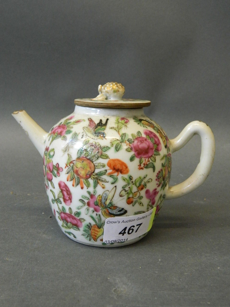 A late C19th Cantonese teapot painted in enamels with birds and butterflies, with gilt lotus