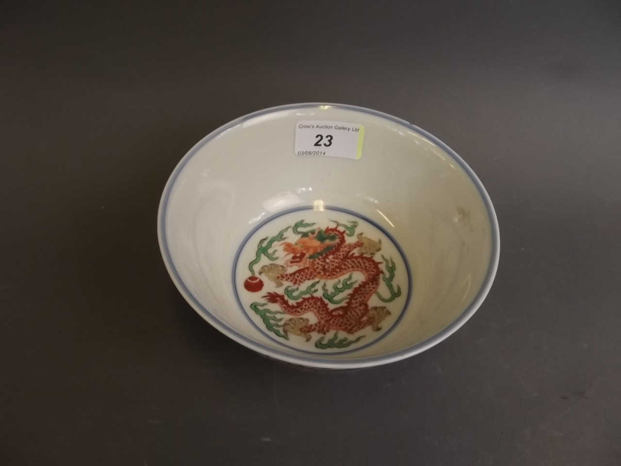 A Chinese Wucai enamel porcelain bowl with painted dragon, phoenix and flaming pearl decoration,