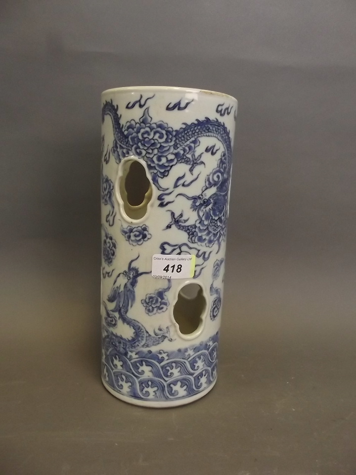 An early C19th Chinese blue and white cylindrical pottery wig stand with pierced decoration, painted