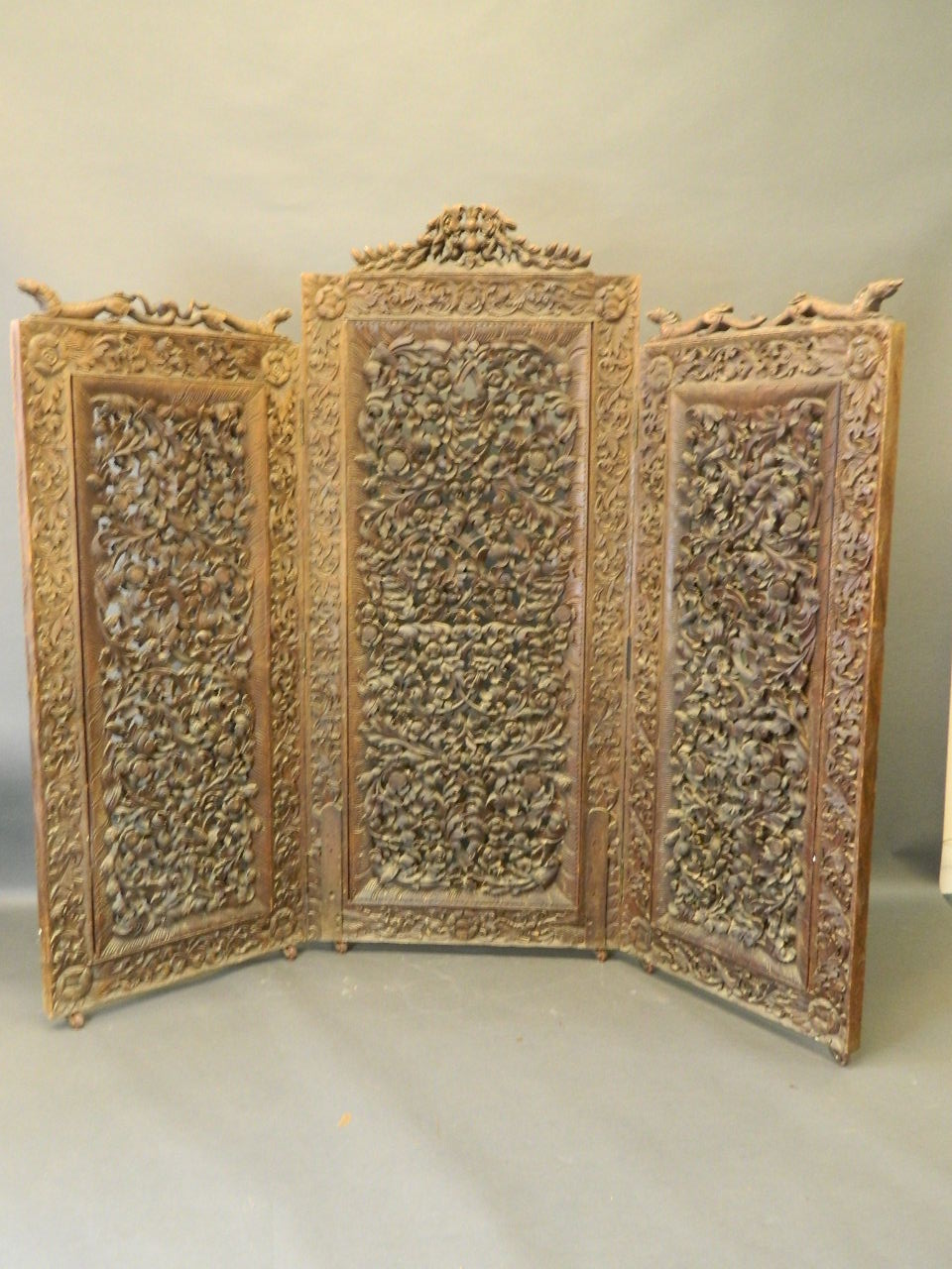 A good mid C19th Burmese carved and pierced hardwood 3 fold screen, deeply carved with stylised