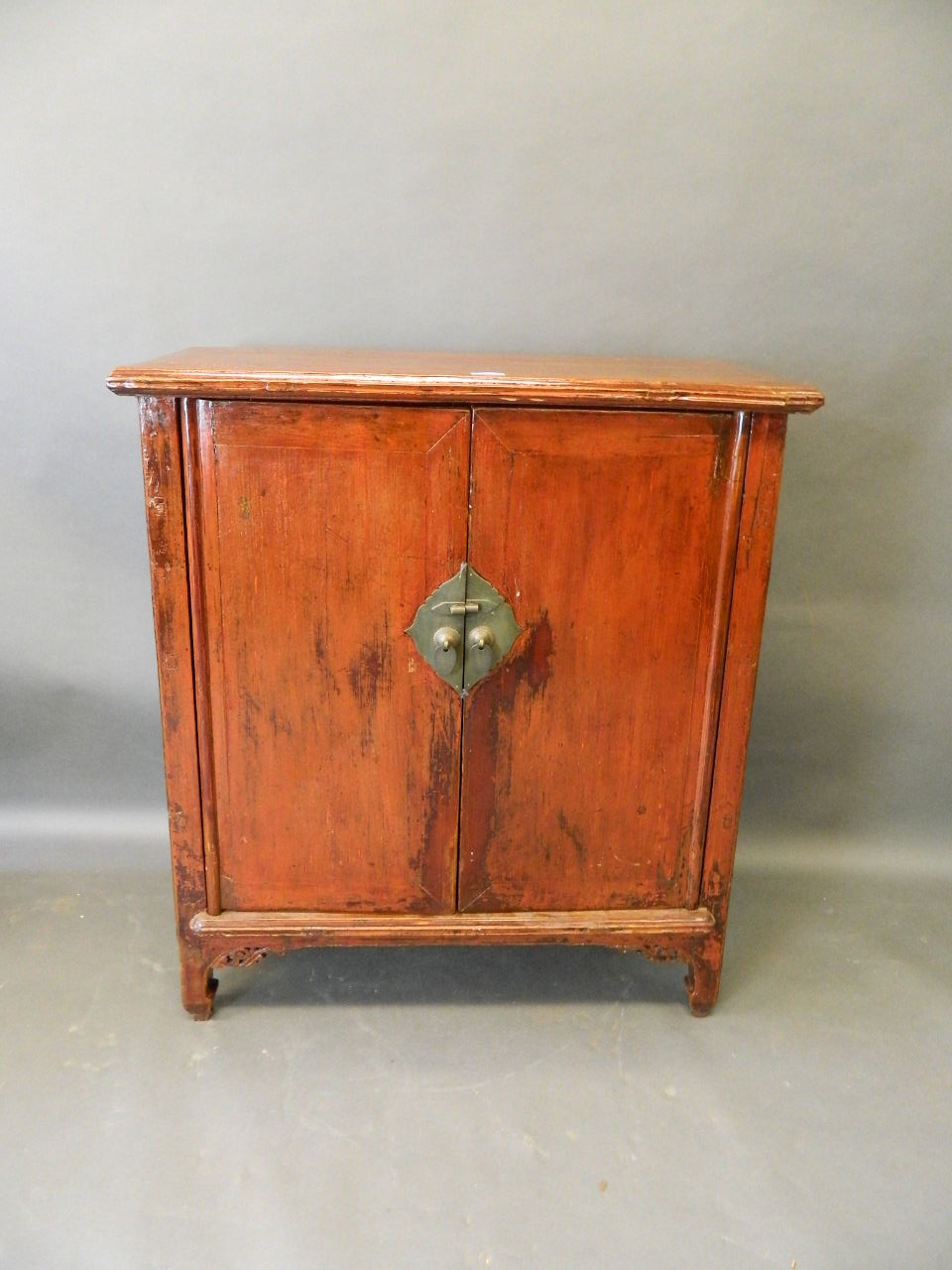 A C19th Chinese fruitwood two door side cupboard with ornate brass handles, 32" wide, 15" deep,