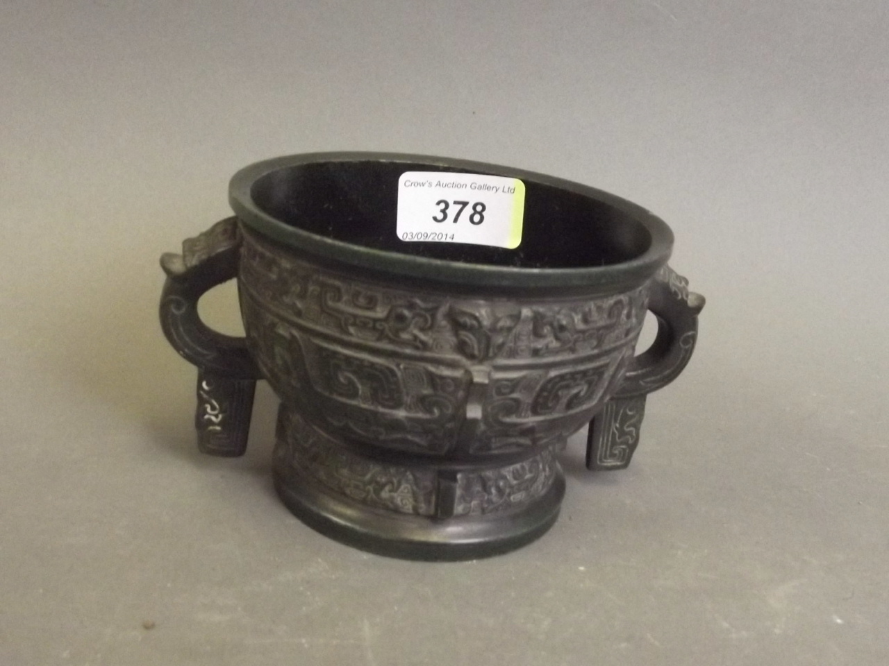 A Chinese twin handled bronze censer with archaic style decoration 5½" dia.