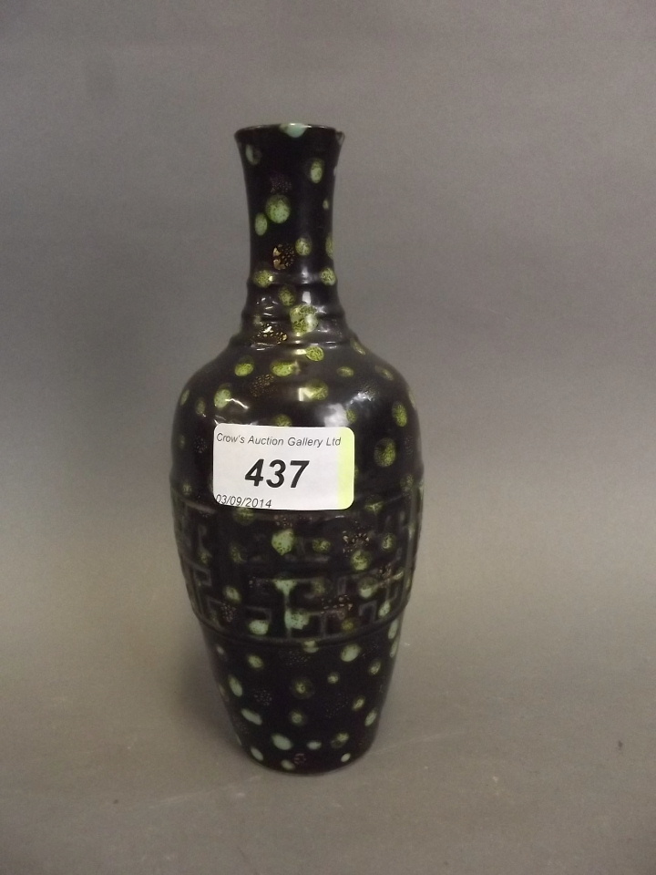 A Chinese black ground green glazed pottery vase with relief decoration, 7¼'' high