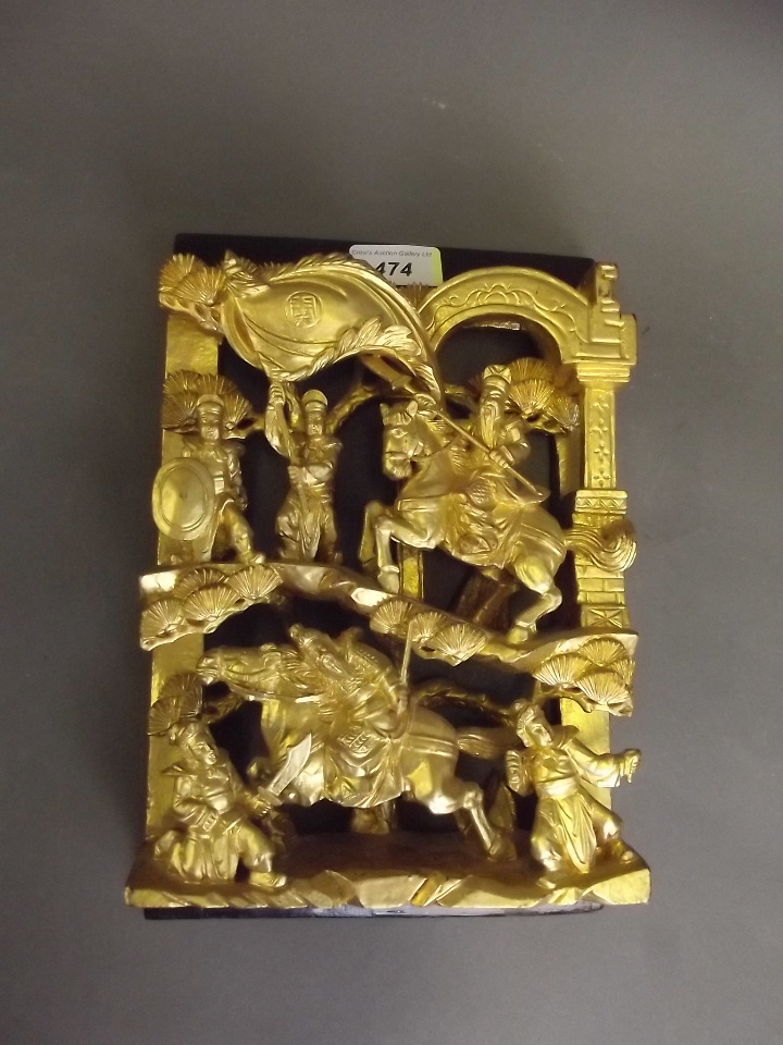 A C19th Chinese carved and pierced giltwood panel depicting warriors on horseback, 10½" x 7"