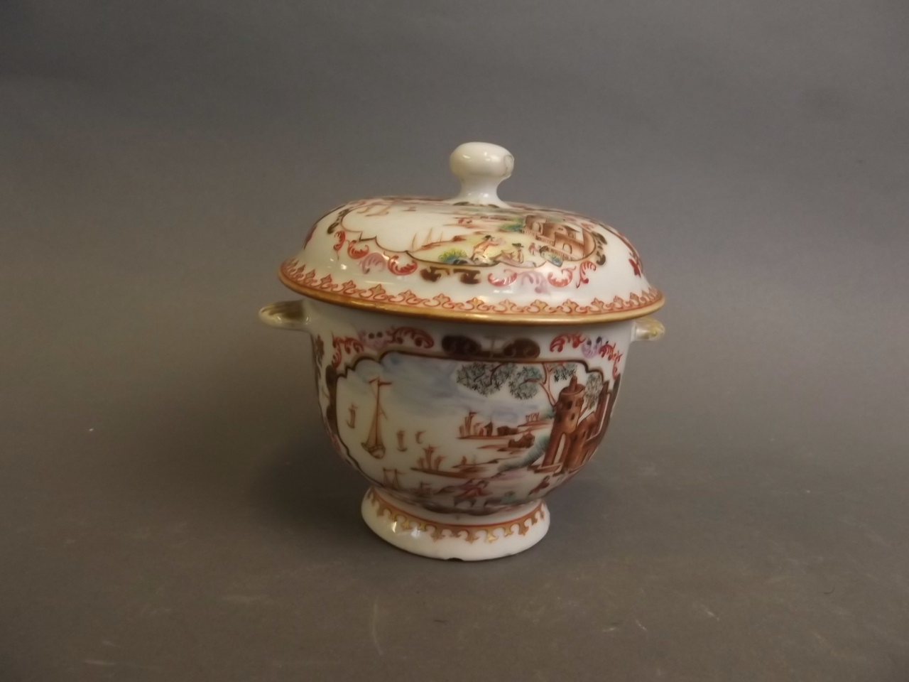 A good C18th Chinese pottery twin handled pot and cover painted with coastal scenes and European