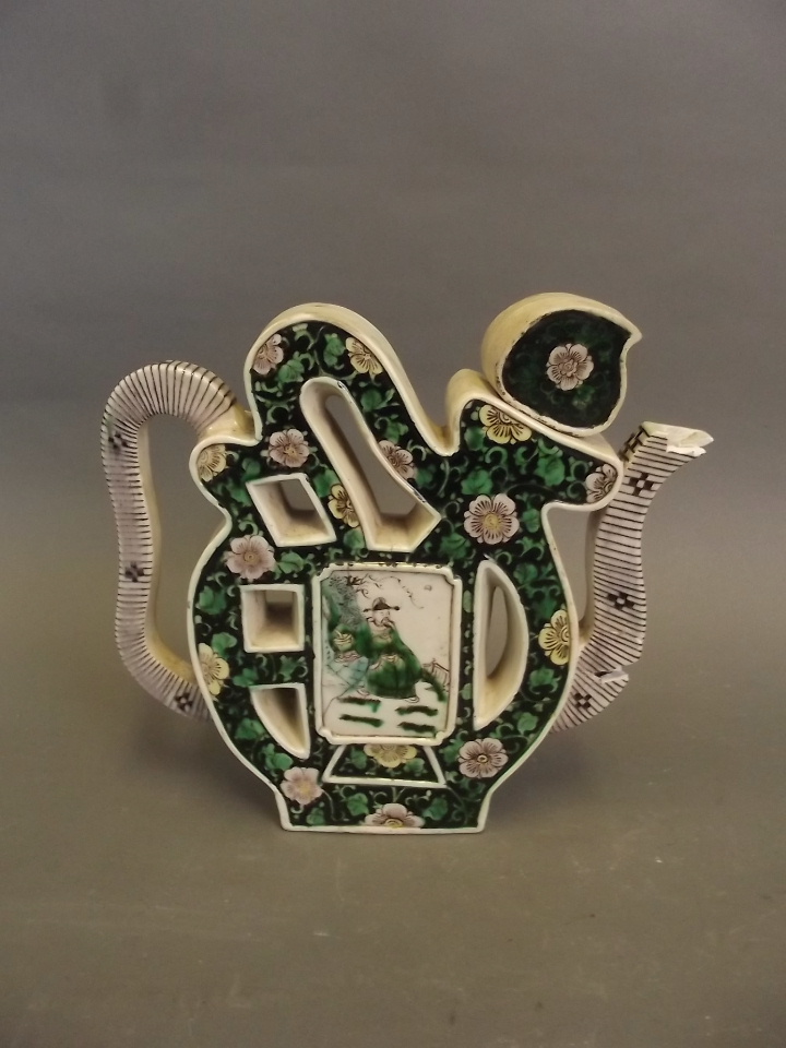An unusual C19th Chinese pottery teapot in the form of a symbol, painted with flowers and a