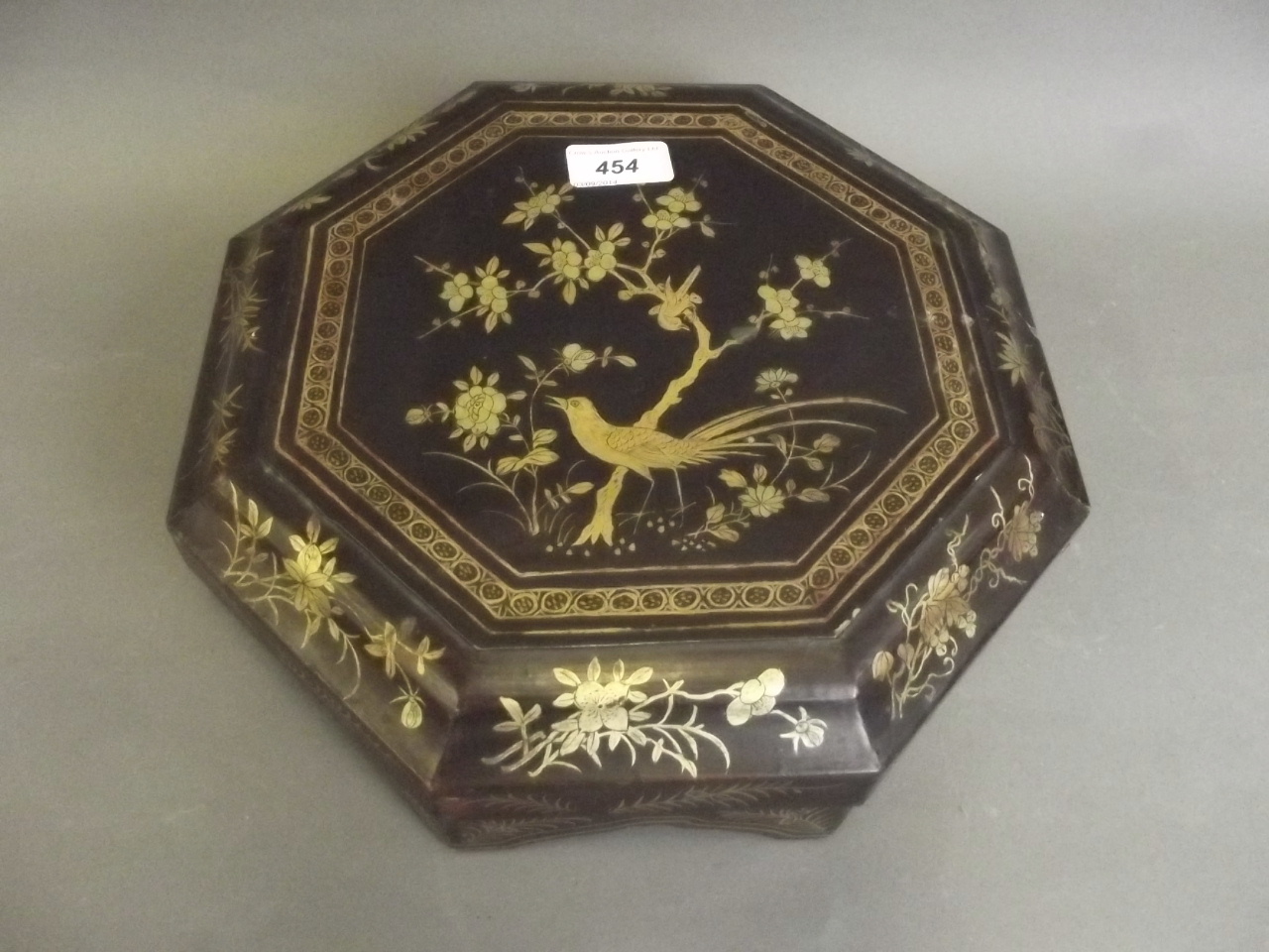 A Chinese octagonal lacquer box containing a set of Cantonese enamelled copper serving dishes, 11½