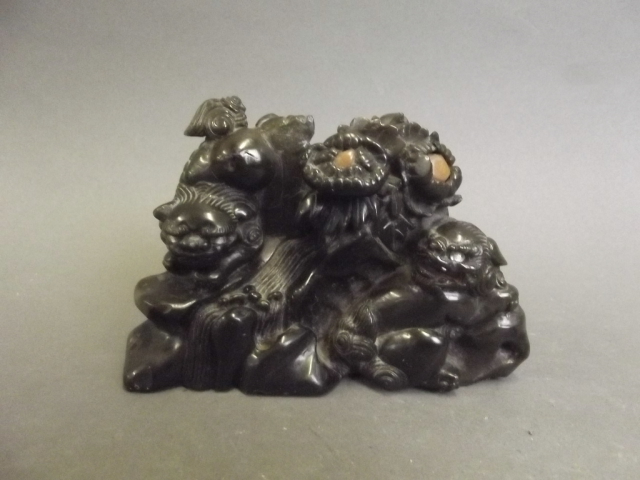 A C19th Chinese carved green hardstone model of two kylins with inset eyes, 5" wide 3¼" high