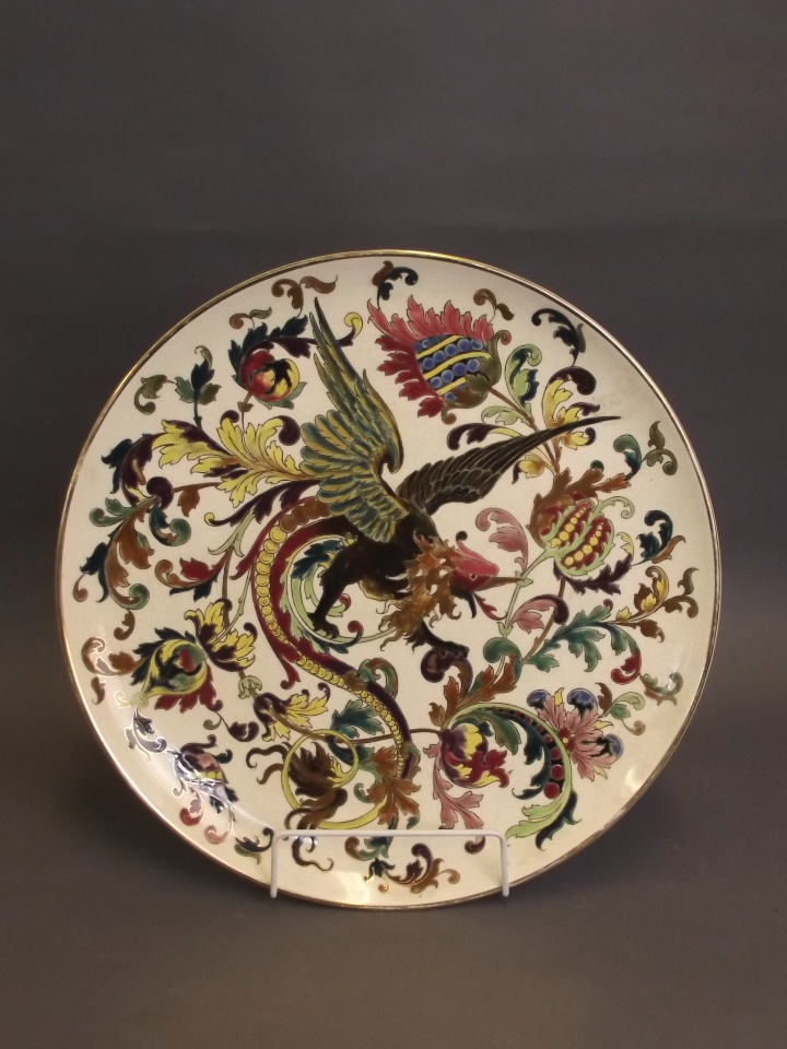 A Zsolnay pottery charger with painted enamel decoration of a phoenix, 15¾" diameter