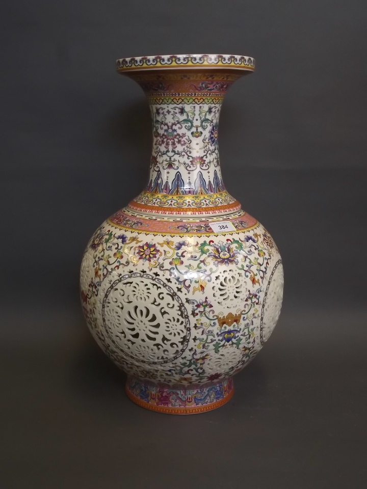 A large Chinese reticulated pottery vase with inner sleeve, decorated in enamels 21" high