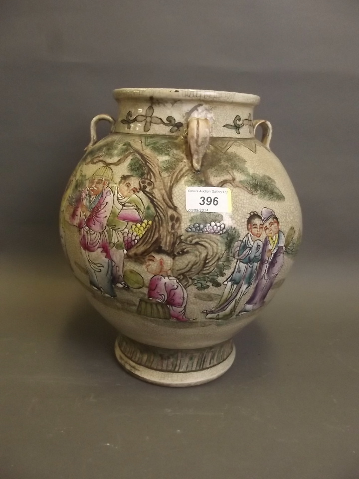 A Chinese crackleglazed pottery vase painted in enamels depicting figures in a garden setting 12"