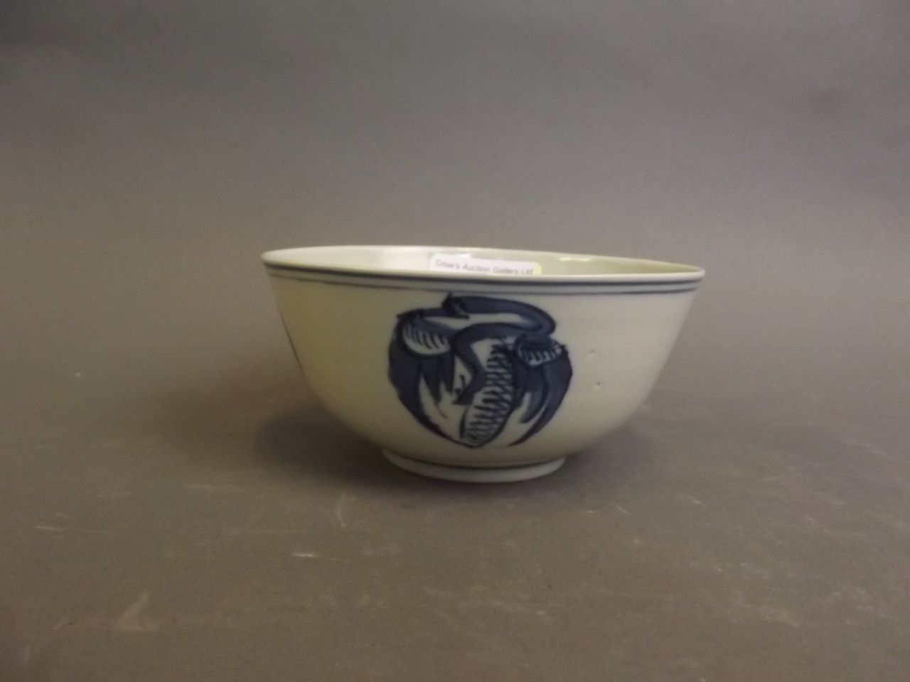 An C18th Chinese blue and white pottery bowl painted with a phoenix, 4½ dia. x 2¼" high